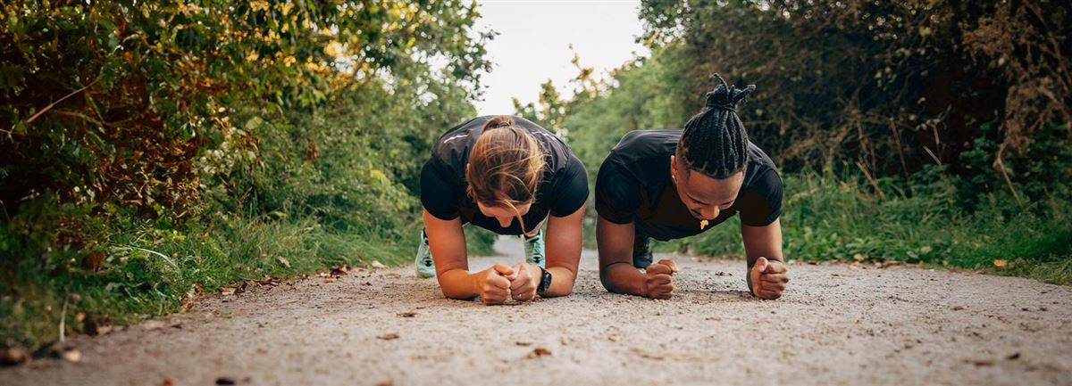 Workout partners doing the plank