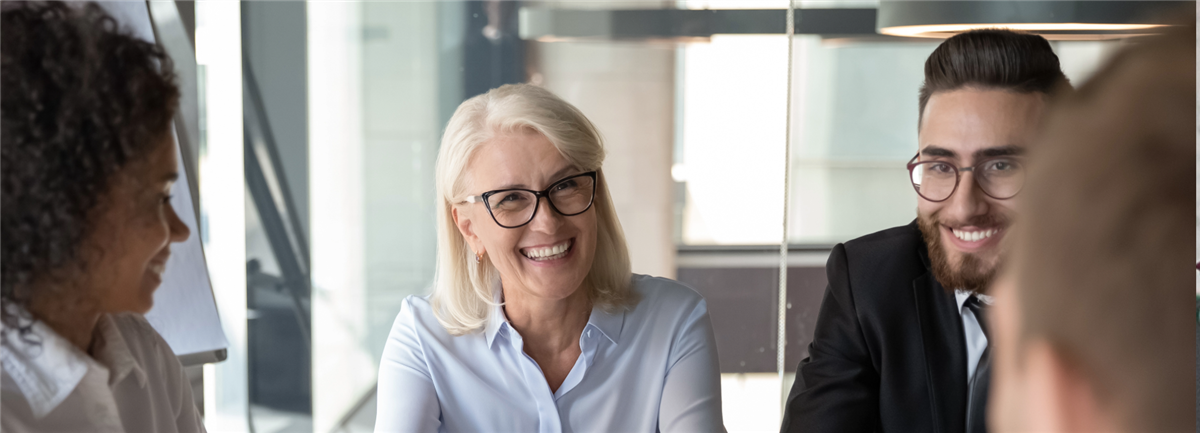 Colleagues smiling around table