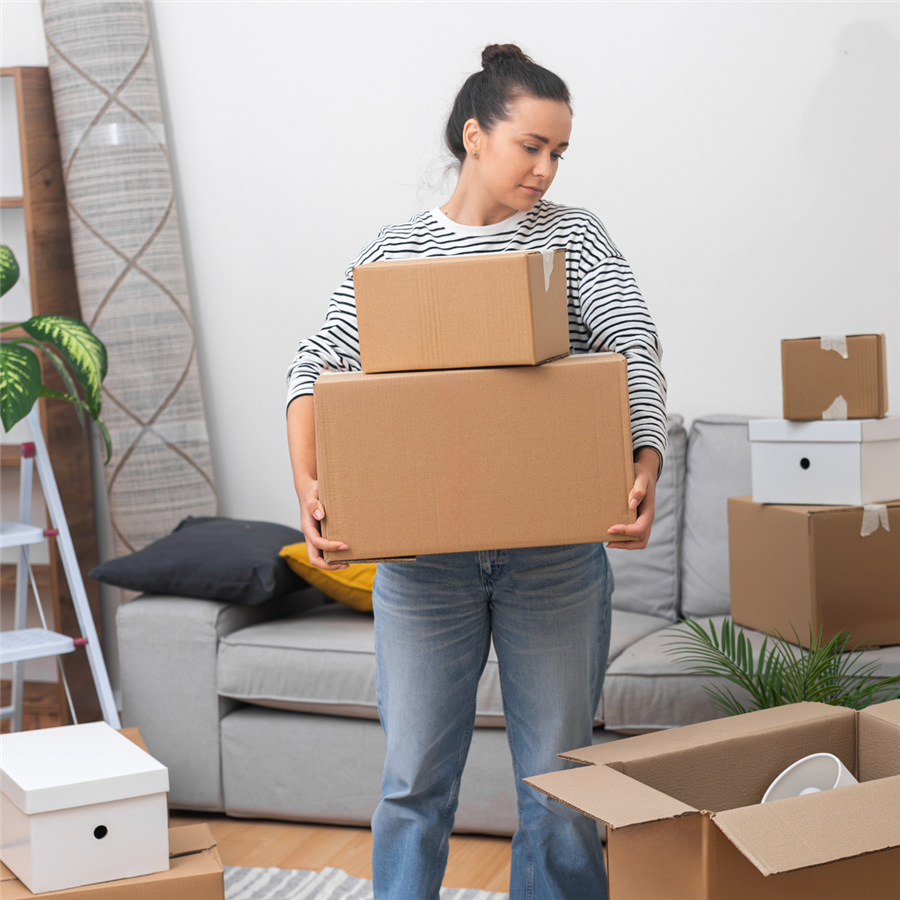 Woman holding boxes, getting ready to move home